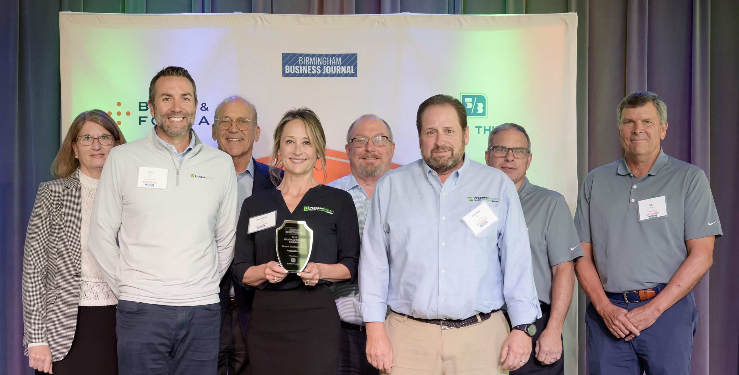 Leadership accepts excellence in manufacturing award