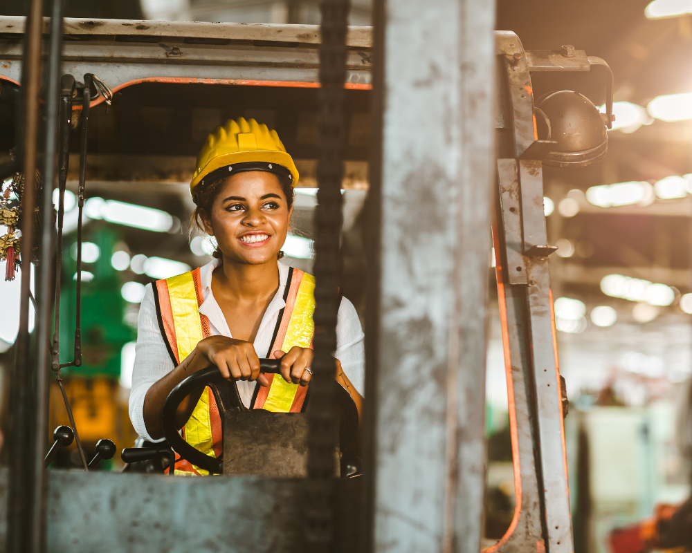 women driving forklift in manufacturing facility